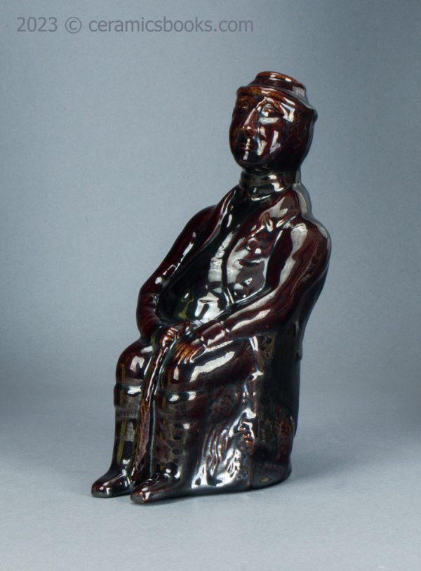 Treacleware spirit flask, old man with walking stick. c.1840-1865. AP/1370. Front obverse.