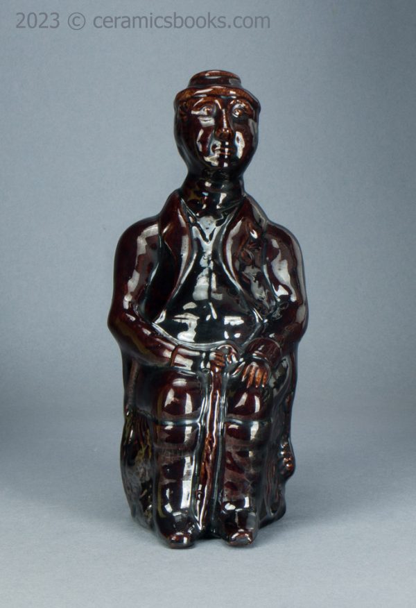 Treacleware spirit flask, old man with walking stick. c.1840-1865. AP/1370. Front.