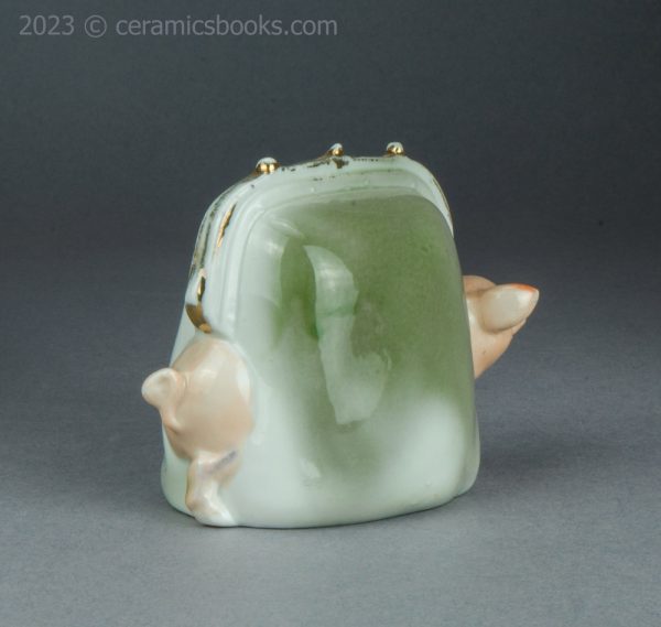 German porcelain pig in a purse moneybox. c.1920-1925. AP/1421. Back reverse.