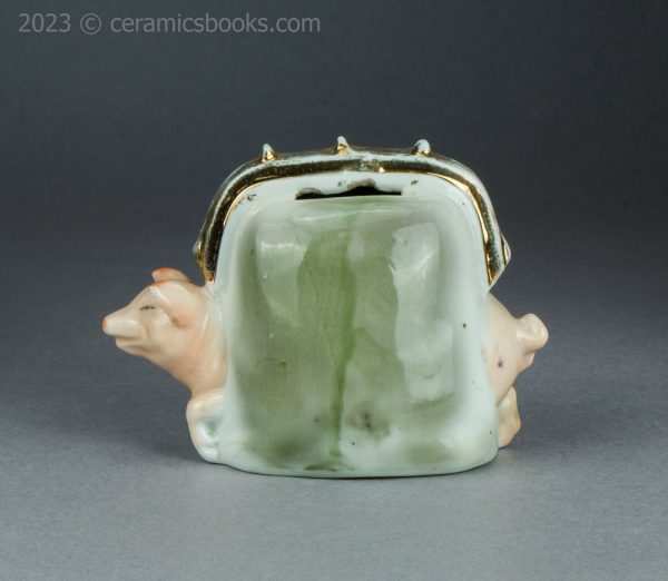 German porcelain pig in a purse moneybox. c.1920-1925. AP/1421. Obverse.
