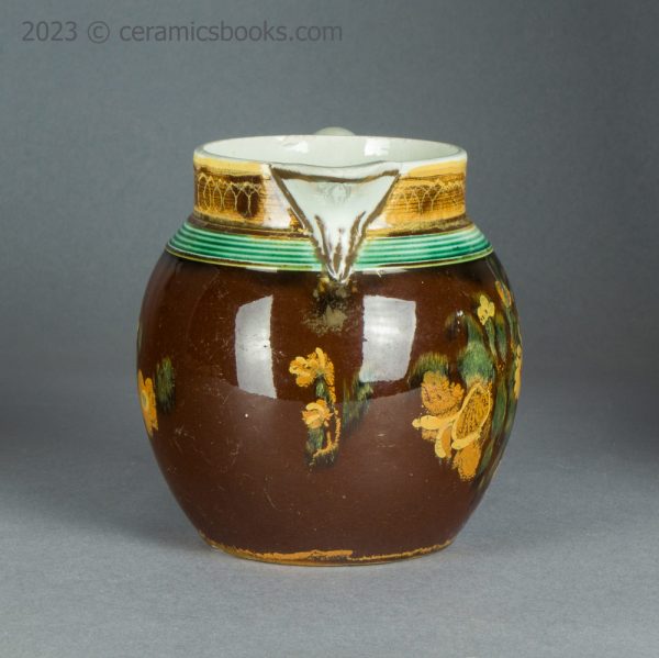 Pearlware jug with brown slip ground and flowers. c.1800-1830. AP/1500. Front.