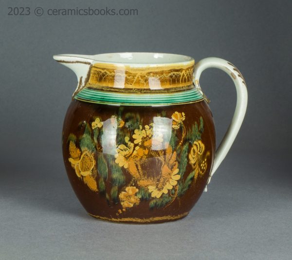 Pearlware jug with brown slip ground and flowers. c.1800-1830. AP/1500. Obverse.