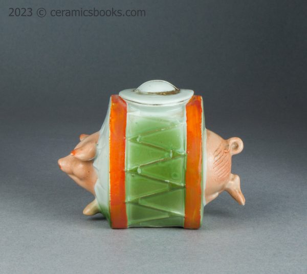 German porcelain moneybox pig running through drum. c.1910-1925. AP/1689. Obverse.