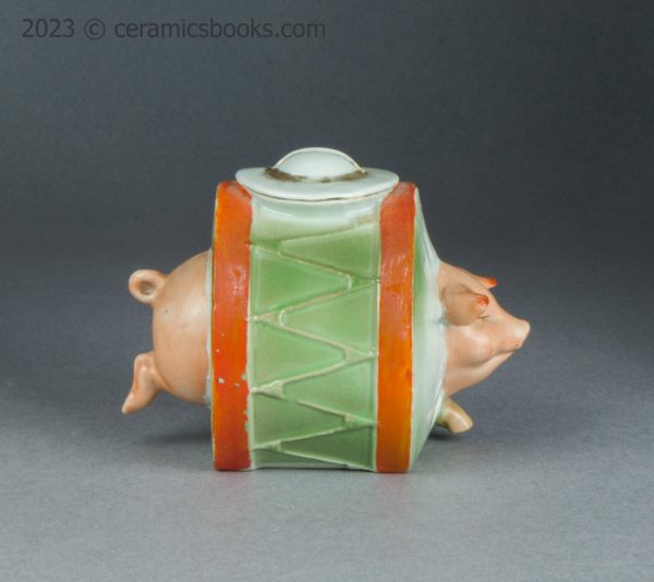 German porcelain moneybox pig running through drum. c.1910-1925. AP/1689. Reverse.