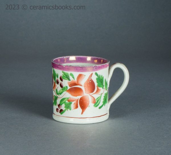 Child's toy mug. Pink lustreware with enamelled flowers. c.1825-1850. AP/1714. Obverse.