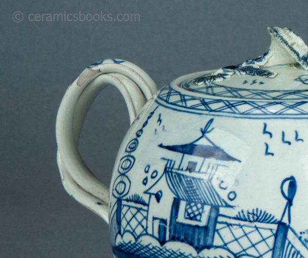 Pearlware teapot, painted blue underglaze Chinese House pattern. Attributed to Leeds Pottery. c.1780-1790. AP1401. Handle chip.