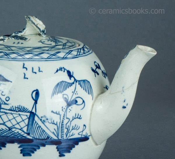 Pearlware teapot, painted blue underglaze Chinese House pattern. Attributed to Leeds Pottery. c.1780-1790. AP1401. Spout repair.