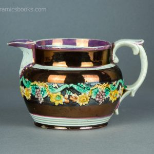 Pearlware jug with pink and copper lustre decoration, and enamelled flower sprigs. c.1820-1830. AP/1474. Obverse.