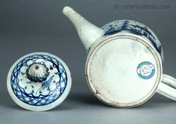 Pearlware cylindrical bachelor teapot with underglaze blue painted 'Chinese House' design. c.1785-1800. AP/1488. Base.