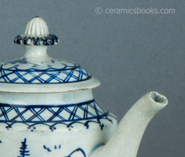 Pearlware cylindrical bachelor teapot with underglaze blue painted 'Chinese House' design. c.1785-1800. AP/1488. Spout lip.