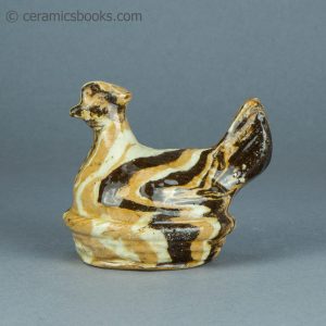 Agateware moneybox. Chicken in a basket. Attributed to Belfield Pottery. c.1870-1895. AP/1552. Obverse.