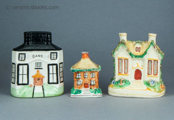 Three Staffordshire moneyboxes. Bank building and two cottages. c.1870-1920.