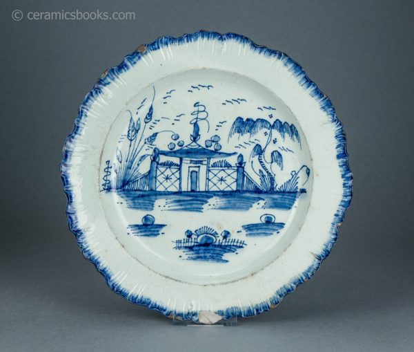 Pearlware shell edge plate. Underglaze blue painted 'Chinese house' pattern. Joshua Heath. c.1785-1800. AP/1703. Front.
