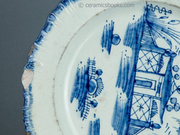 Pearlware shell edge plate. Underglaze blue painted 'Chinese house' pattern. Joshua Heath. c.1785-1800. AP/1703. Rim chip A.