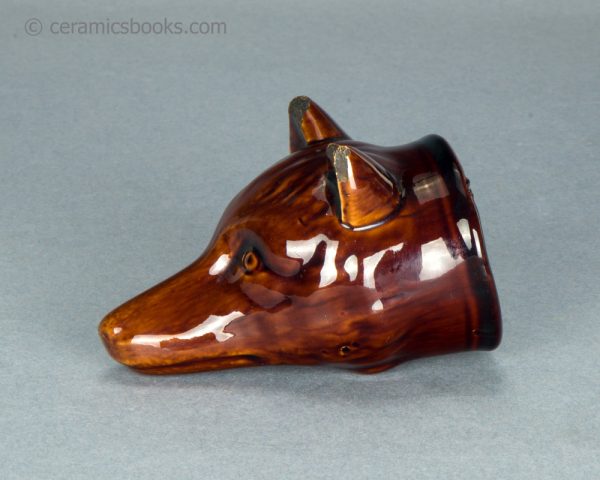 Treacleware fox head stirrup cup. c.1835-1865. AP/1062. Obverse.