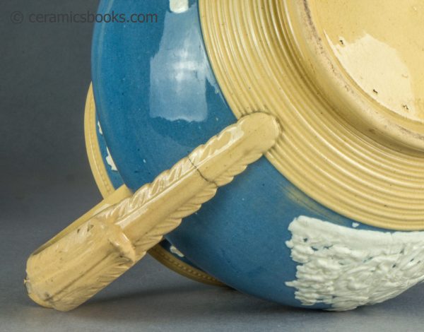 Large yellowware jug with blue slip ground and white sprigs. c.1840-1860. AP/1411. Handle hairline.
