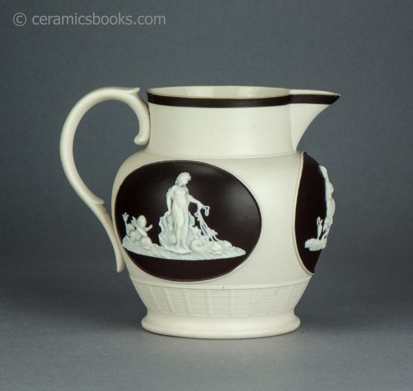 Felspathic stoneware jug with sprigs inside brown slip cartouches. Chetham & Woolley. c.1800-1810. AP/1643. Reverse.